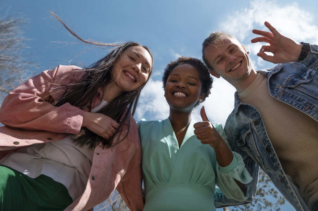 group friends celebrating lifting face mask restrictions outdoors